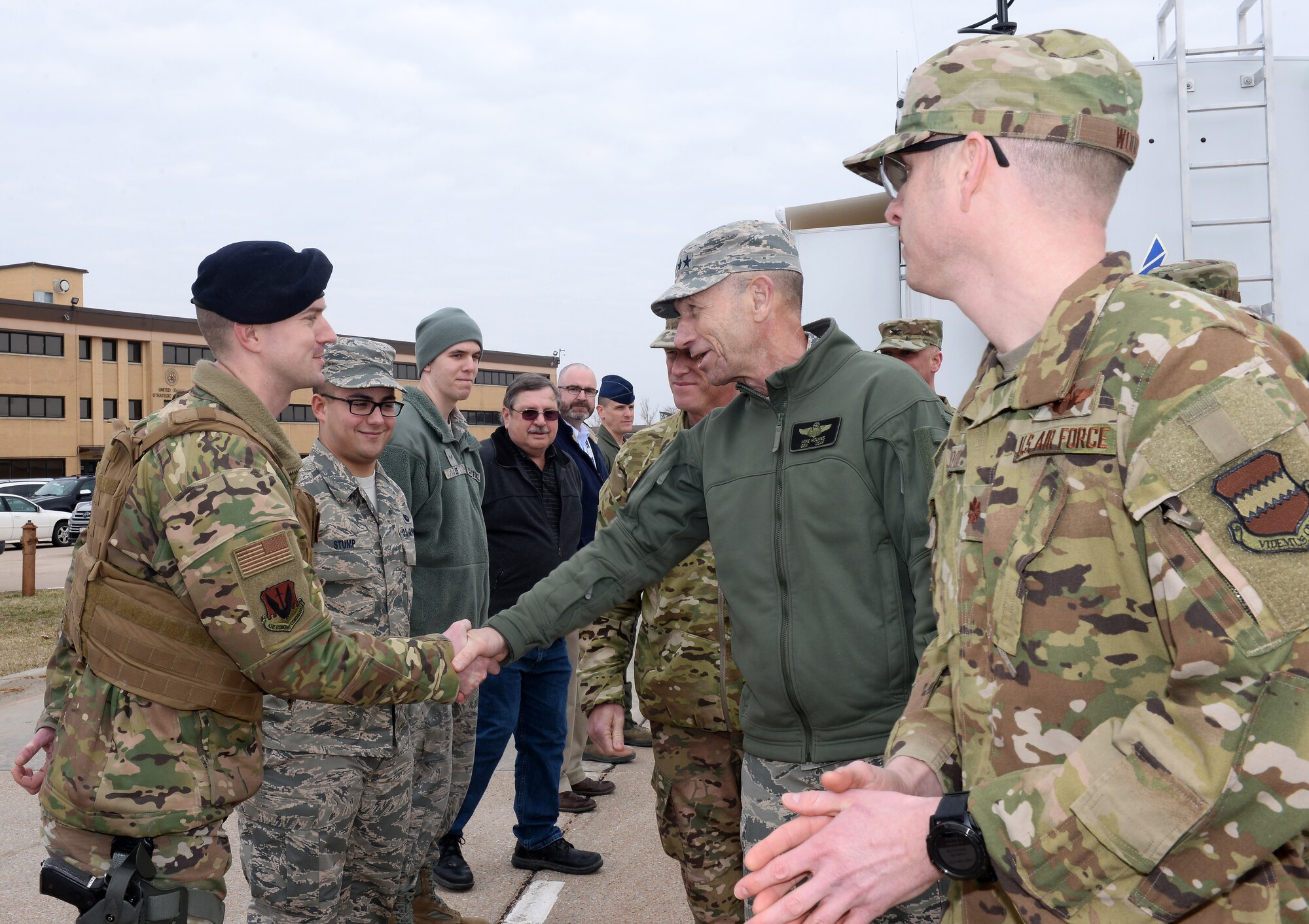 U.S. Air Force Gen. Mike Holmes, commander of Air Combat Command, thanks U.S. Air Force Staff Sgt. Michael Buchanan, 55th Security Forces Squadron, for his flood preparation efforts during the general's visit to Offutt Air Force Base, Nebraska, March 25, 2019. Just 10 days earlier, the base began taking on water, which eventually covered one-third of the installation. (Photo by Charles Haymond)