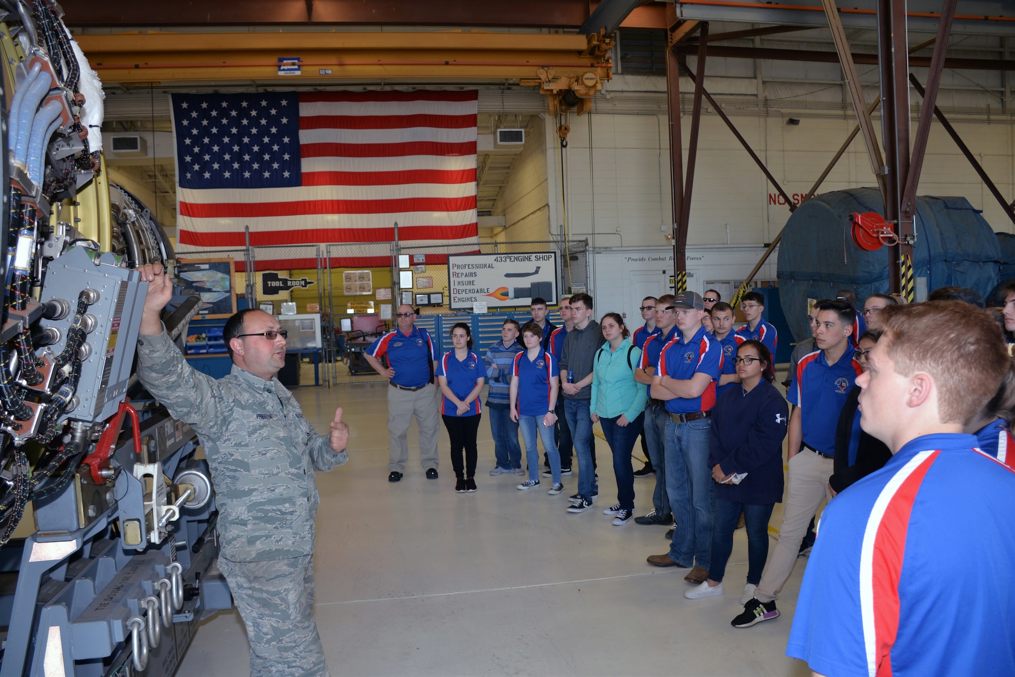 Master Sgt. Sean C. Preston, 433rd Maintenance Squadron propulsion mechanic, describes the features of a C-5M Super Galaxy engine to Burleson Independent School District Air Force Junior ROTC students March 22, 2019 at Joint Base San Antonio-Lackland, Texas.