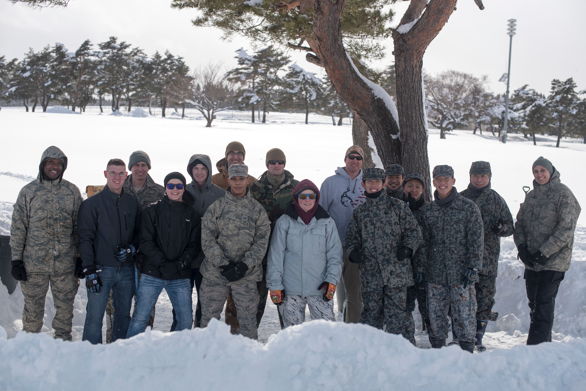 U.S. Air Force Airmen with the 35th Civil Engineer Squadron emergency management flight and Japan Air Self-Defense Force members pause for a photo during the inaugural “Snowblast” event at Misawa Air Base, Japan, Feb. 14, 2019. The emergency flight gathered for a snowball fight and capture the flag events with members of JASDF. This event provided an opportunity for Airmen to bond with their host-nation counterparts. (U.S. Air Force photo by 1st Lt. Jeremy Garcia).