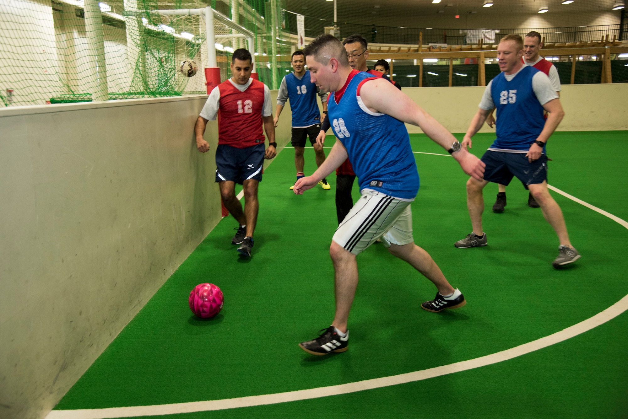American and Japanese security forces members run for a ball in a bilateral soccer game at Misawa Air Base, Japan, March 15, 2019.  This sporting event provided a way for both squadrons to connect and team build, which is crucial for the U.S.-Japan alliance. (U.S. Air Force photo by Branden Yamada)
