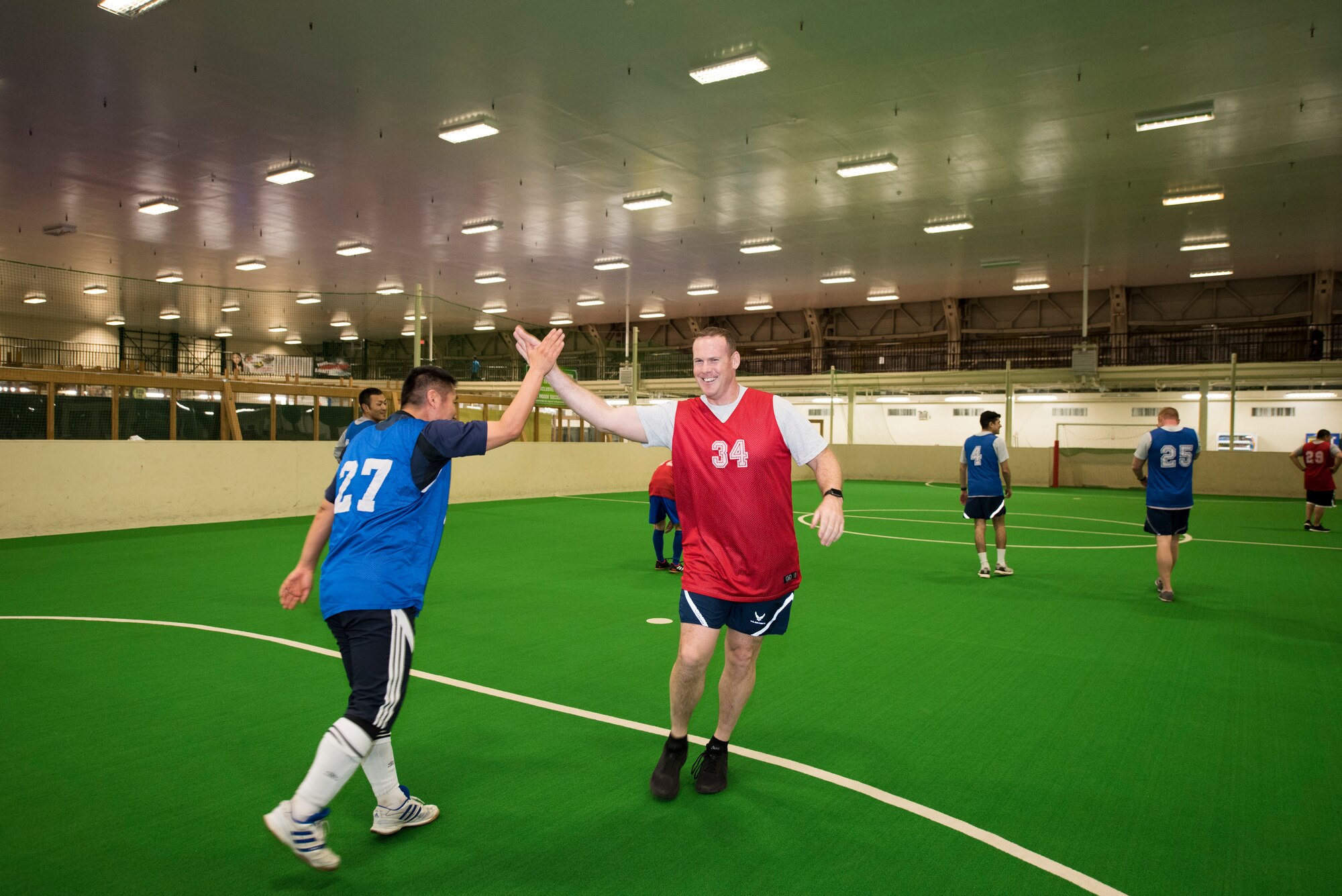 U.S. Air Force Senior Master Sgt. Bruce Rick, right, the 35th Security Forces Squadron operations superintendent, and Staff Sgt. Shouta Hasegawa, left, a 3rd Air Wing security guard, high five during a bilateral soccer game at Misawa Air Base, Japan, March 15, 2019.  The soccer game is one of many events hosted by Misawa AB to increase camaraderie and teamwork. (U.S. Air Force photo by Branden Yamada)