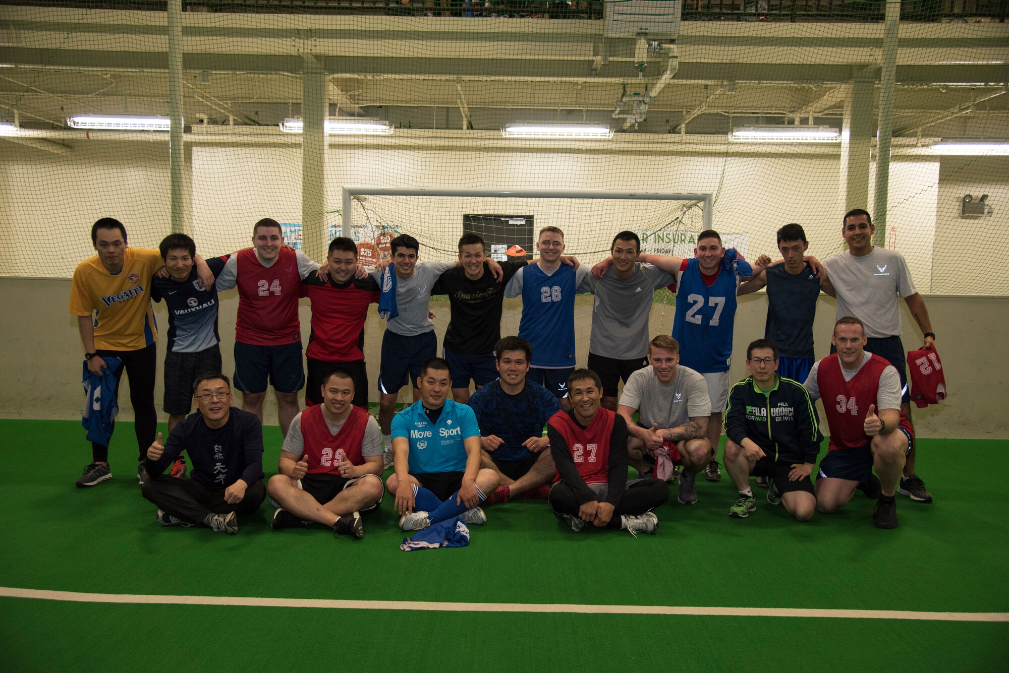 U.S. Air Force and Japan Air Self-Defense Force security forces members pose for a group photo after a bilateral soccer game at Misawa Air Base, Japan, March 15, 2019.  Both teams played roughly six short games over the span of an hour.  (U.S. Air Force photo by Branden Yamada)