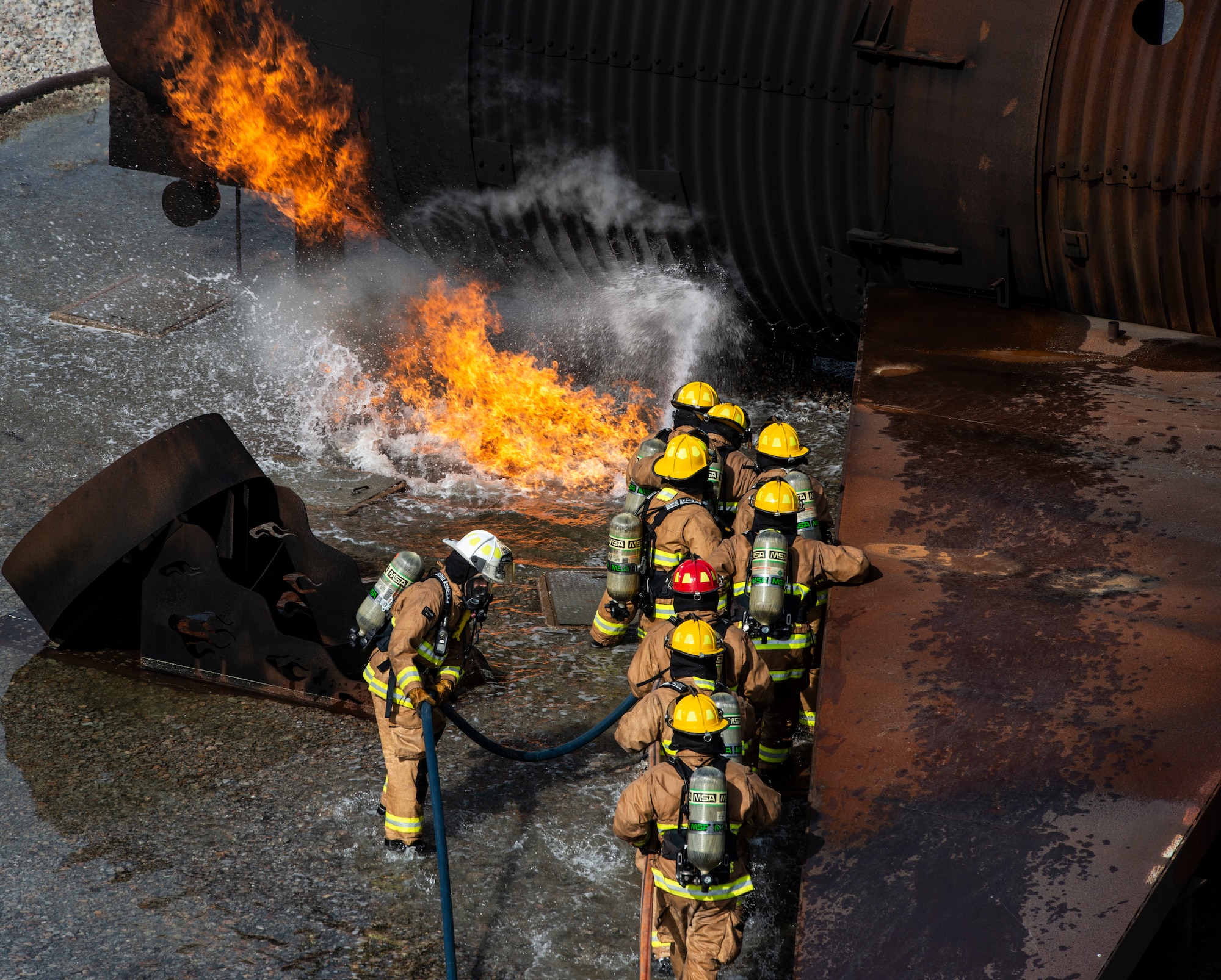U.S. Air National Guardsmen from Maine, Connecticut and New Hampshire Civil Engineer Squadrons extinguish a mock C-130 Hercules aircraft fire during a live fire training scenario at Shaw Air Force Base, S.C., March 19, 2019.