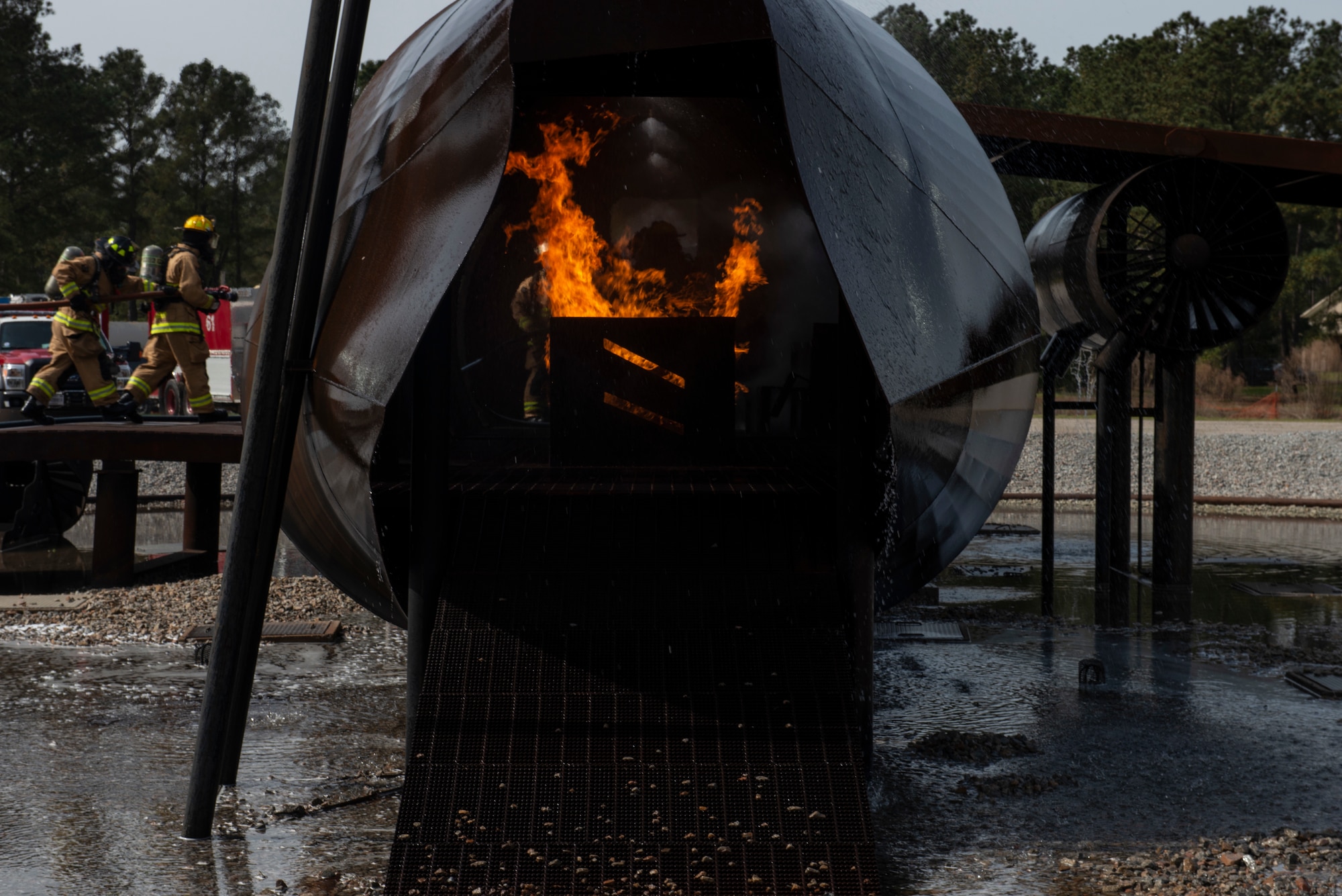 U.S. Air National Guardsmen from Maine, Connecticut and New Hampshire Civil Engineer Squadrons extinguish flames during a live fire training at Shaw Air Force Base, S.C., March 19, 2019.