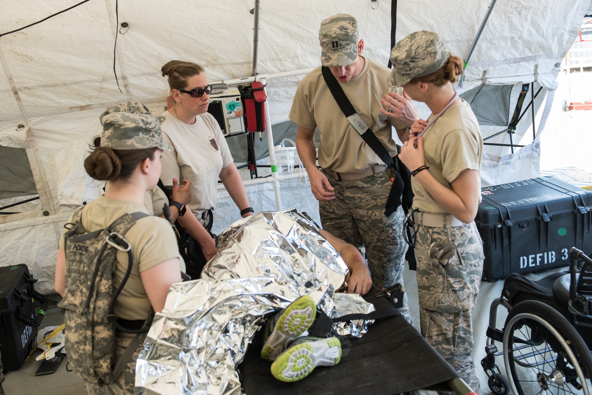 U.S. Airmen with the 193rd Special Operations Medical Group Detachment 1, Pennsylvania Air National Guard, discuss the treatment of casualty actor during exercise Vigilant Guard.