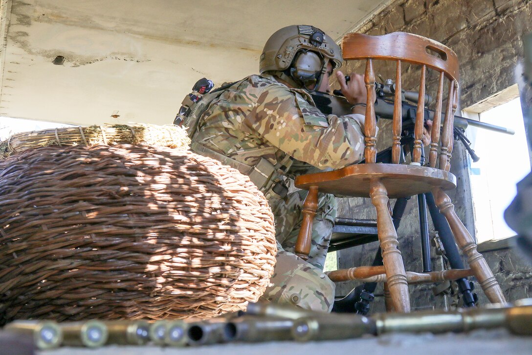 A service member prepares to fire a weapon.