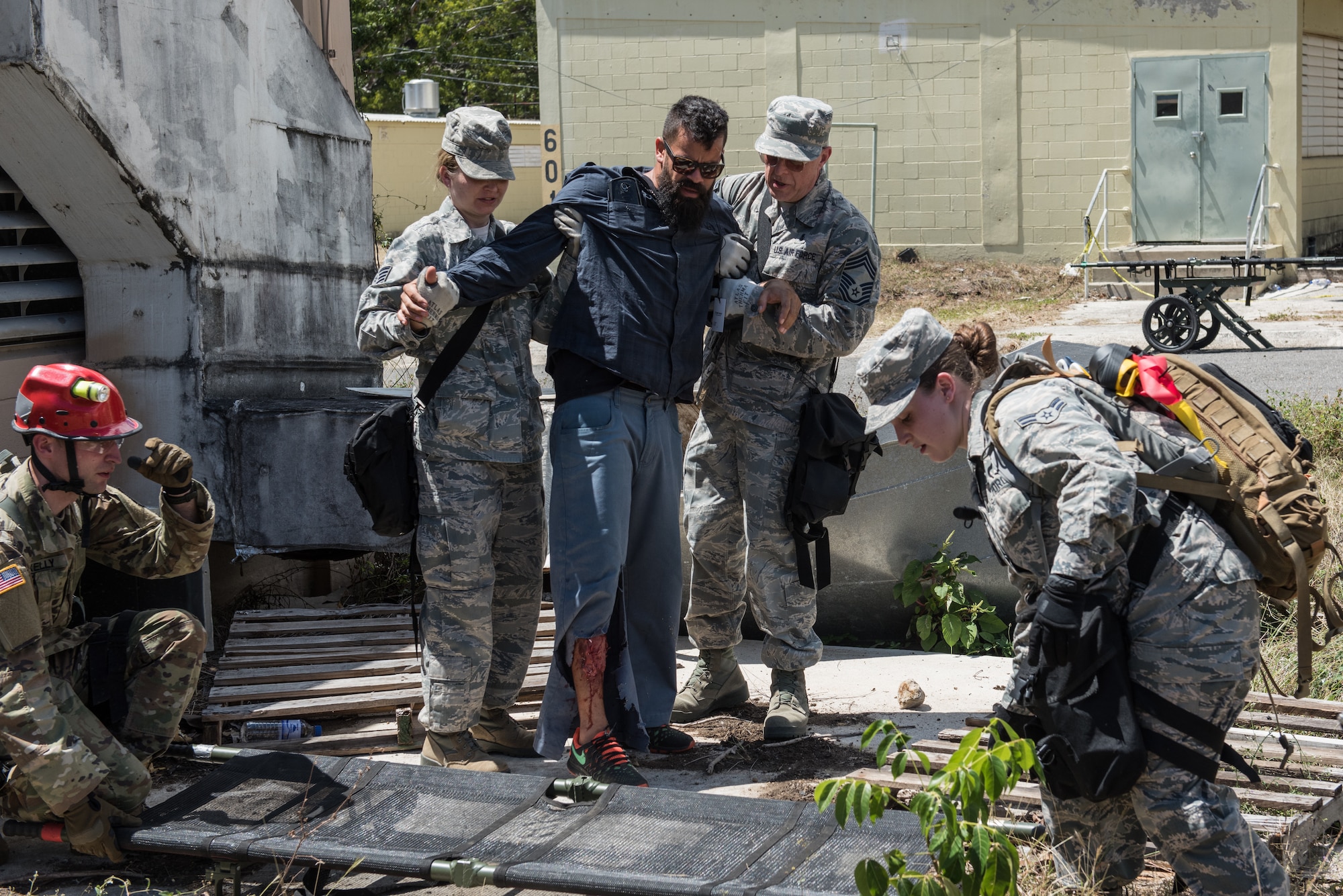 U.S. Airmen and Soldiers from the 3rd Chemical, Biological, Radiological, Nuclear Task Force, Pennsylvania National Guard, help evacuate a casualty actor during the exercise Vigilant Guard.