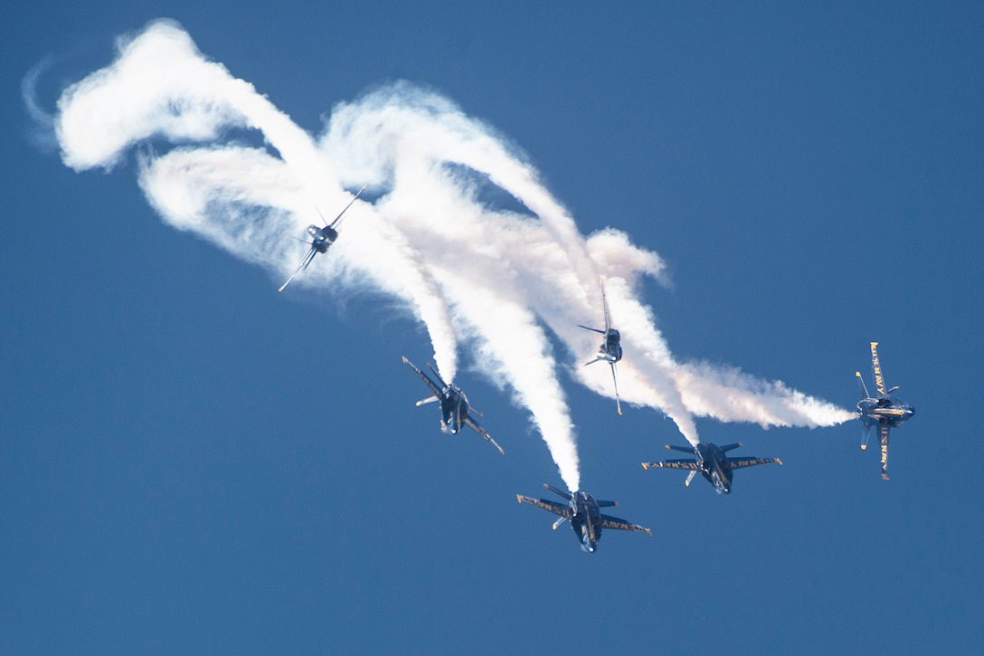 Navy planes fly in formation.