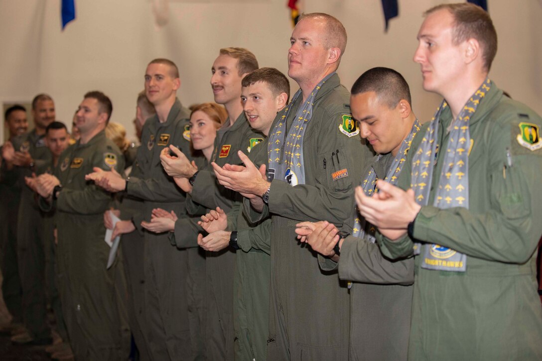 Members of Formal Training Unit Class 18-02 applaud at the end of their graduation ceremony at Barksdale Air Force Base, Louisiana, March 22, 2019.  More than 25 new bomber aircrew joined the ranks of the B-52 Stratofortress community during the ceremony. (U.S. Air Force photo by Master Sgt. Ted Daigle)