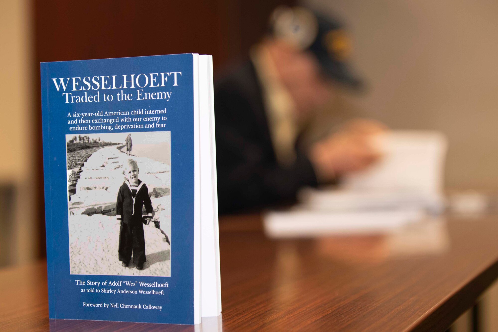 Retired Lt. Col. Adolf Wesselhoeft signs a copy of his  autobiography for members fo the 307th Bomb Wing at Barksdale Air Force Base, Louisiana, March 22, 2019.  He was attending the graduation ceremony for Formal Traiing Unit Class 18-02 and provided the books at no cost after the event.  Wesselhoeft was deported from the United States at age seven only to return and become a B-52 Stratofortress navigator.  (U.S. Air Force photo by Master Sgt. Ted Daigle)