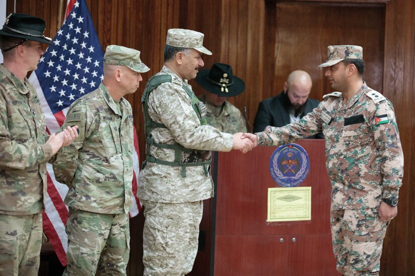 U.S. Army Lt. Col. Jeremy T. Hopkins, 1st Squadron, 18th Cavalry Regiment, commander, Brig. Gen. Michael D. Wickman, deputy commanding general-maneuver, 34th Infantry Division Forward, Jordan, and Jordan Armed Forces Brig. Gen. Khalid Mohammed Al-Masaeid, Northern Region commander, congratulate company commanders in the 10th Border Guard Force Battalion (BGF) during their graduation ceremony the Peace Operations Training Center near Amman, Jordan, March 14, 2019. The JAF soldier’s graduation from the Joint Operational Engagement Program signified the completion of a 10-week training program with the California Army National Guard’s 1-18 CAV to develop and strengthen soldier skills for the 10th BGF.