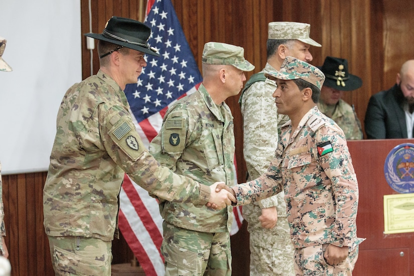 U.S. Army Lt. Col. Jeremy T. Hopkins, 1st Squadron, 18th Cavalry Regiment, commander, Brig. Gen. Michael D. Wickman, deputy commanding general-maneuver, 34th Infantry Division Forward, Jordan, and Jordan Armed Forces Brig. Gen. Khalid Mohammed Al-Masaeid, Northern Region commander, congratulate company commanders in the 10th Border Guard Force Battalion (BGF) during their graduation ceremony the Peace Operations Training Center near Amman, Jordan, March 14, 2019. The JAF soldiers’ graduation from the Joint Operational Engagement Program signified the completion of a 10-week training program with the California Army National Guard’s 1-18 CAV to develop and strengthen soldier skills for the 10th BGF.