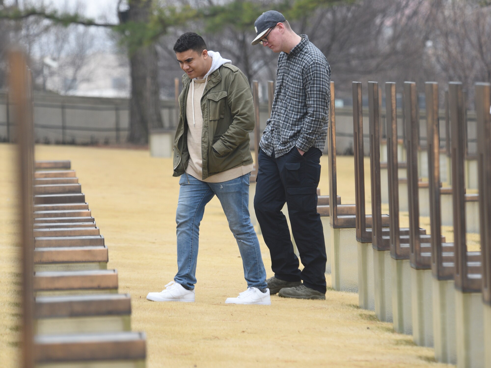 Airmen 1st Class Christian Esquivel and Joshua Cooper look at the names of those who died in the Alfred P. Murrah Federal Building bombing as they learn about the tragic event during Tinker Air Force Base’s First Term Airmen Center tour of downtown Oklahoma City on March 8, 2019
