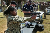 U.S. and coalition military personnel from U.S. Central Command, U.S. Special Operations Command and MacDill Air Force Base fire non-lethal weapons during a familiarization fire at MacDill AFB, March 21, 2019.