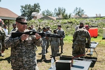 U.S. and coalition military personnel from U.S. Central Command, U.S. Special Operations Command and MacDill Air Force Base fire non-lethal weapons during a familiarization fire at MacDill AFB, March 21, 2019.