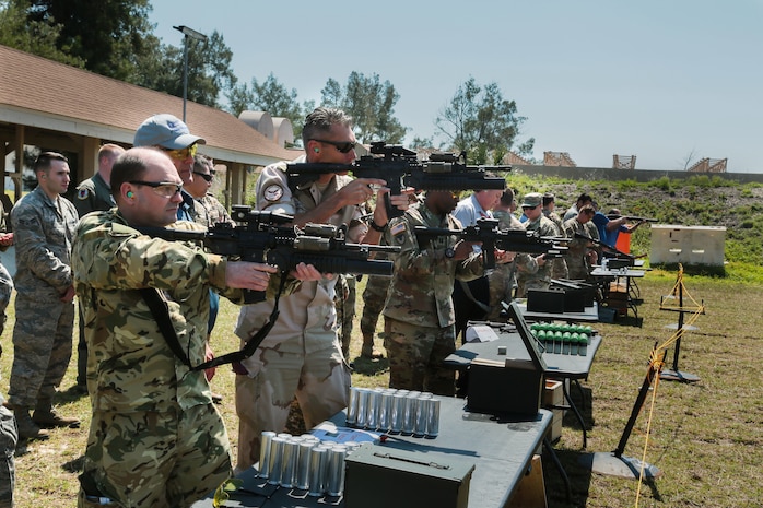 U.S. and coalition military personnel from U.S. Central Command, U.S. Special Operations Command and MacDill Air Force Base fire non-lethal weapons during a familiarization fire at MacDill AFB, March 21, 2019.