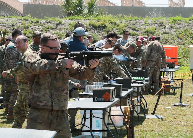 U.S. and coalition military personnel from U.S. Central Command, U.S. Special Operations Command and MacDill Air Force Base fire non-lethal weapons during a familiarization fire at MacDill AFB, March 21, 2019.