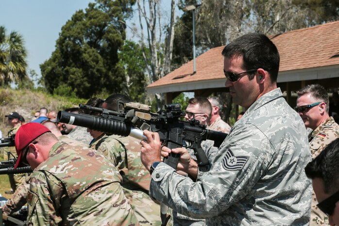 U.S. and coalition military personnel from U.S. Central Command, U.S. Special Operations Command and MacDill Air Force Base fire non-lethal weapons during a familiarization fire at MacDill AFB, March 21, 2019.