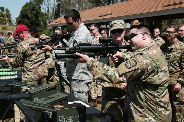 U.S. and coalition military personnel from U.S. Central Command, U.S. Special Operations Command and MacDill Air Force Base fire non-lethal weapons during a familiarization fire at MacDill AFB, March 21, 2019.