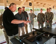 U.S. and coalition military personnel from U.S. Central Command, U.S. Special Operations Command and MacDill Air Force Base fire non-lethal weapons during a familiarization fire at MacDill AFB, March 21, 2019.