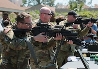 U.S. and coalition military personnel from U.S. Central Command, U.S. Special Operations Command and MacDill Air Force Base fire non-lethal weapons during a familiarization fire at MacDill AFB, March 21, 2019.