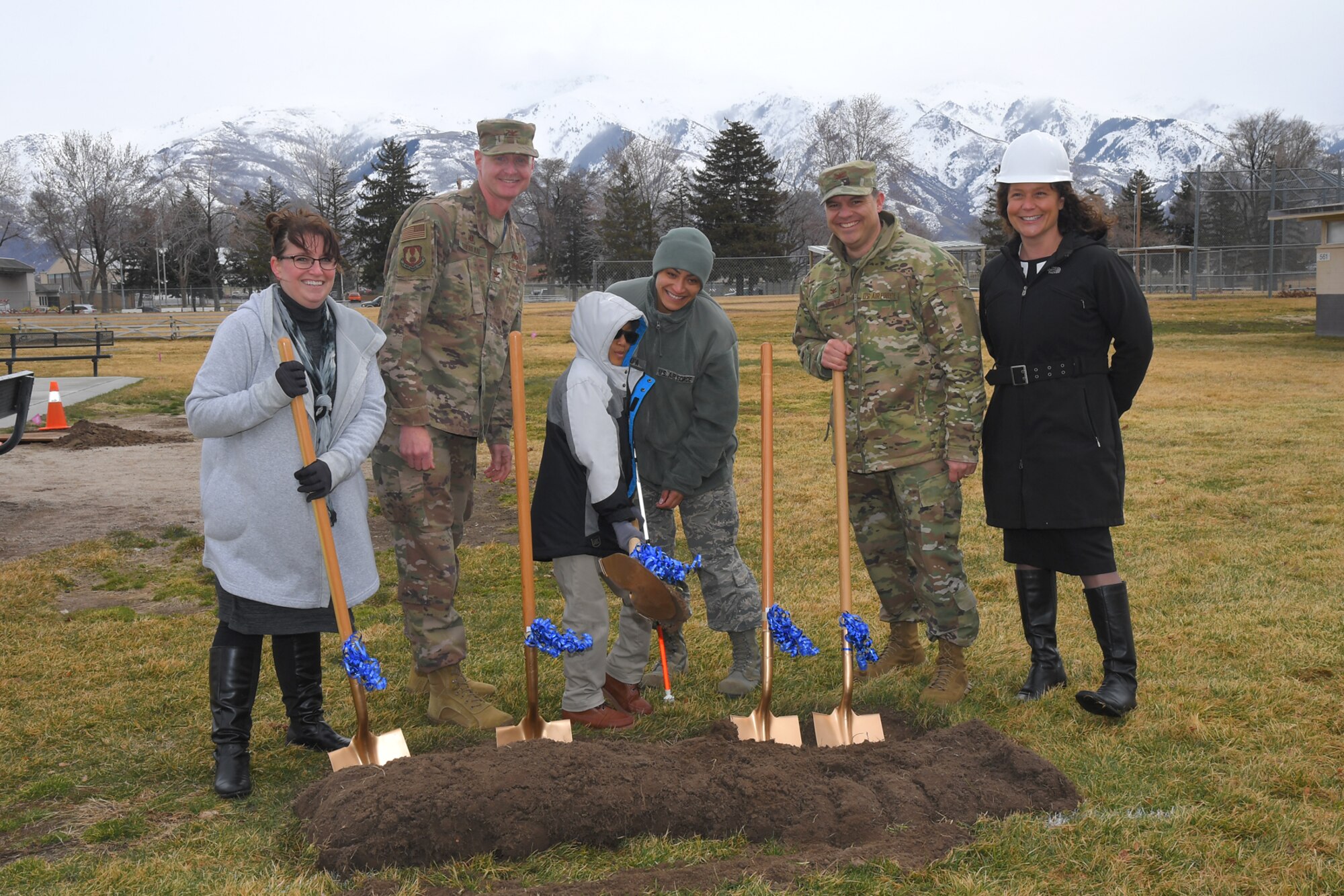 (Center) Keanu Clark and his mother, Tech. Sgt. Elentra Suafoa, 388th Fighter Wing, participate in a ground breaking for an all abilities playground March 21, 2019, at Hill Air Force Base, Utah. The playground will remove barriers of exclusion, both physical and social, and provide a sensory rich experience for children of all abilities. Playground completion is planned for June 2019. Also participating, (left to right) Tammy Custer, Exceptional Family Member Program specialist, Col. Jon Eberlan, 75th Air Base Wing commander, Col. Gabe Lopez, 75th Mission Support Group commander, and Ali Seligman, EFMP specialist. (U.S. Air Force photo by Todd Cromar)