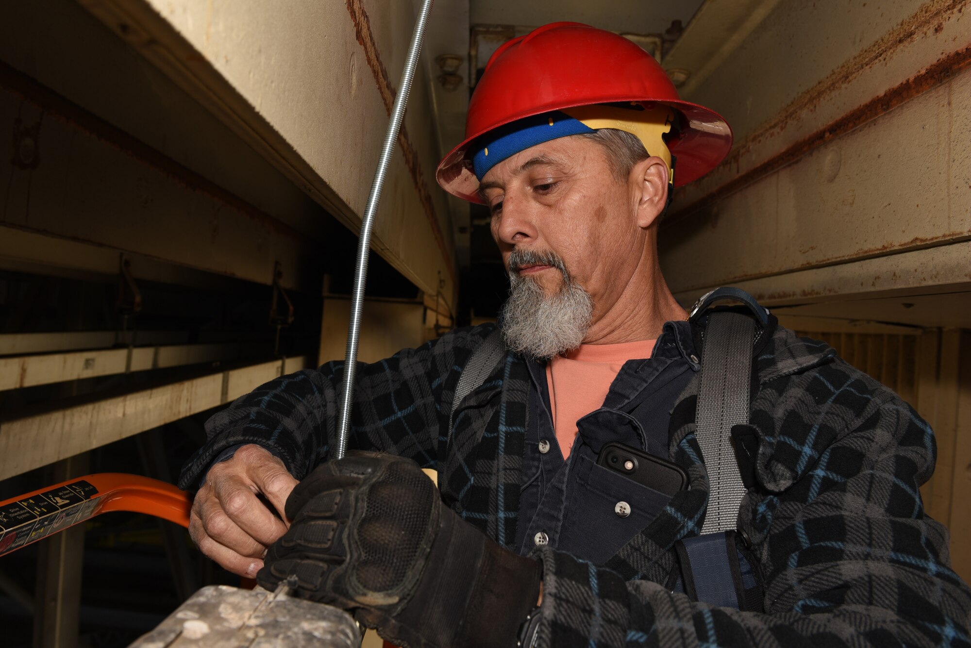 Randall Ollenberger, 60th Civil Engineering Squadron electrician, lines up a hangar door rail March 14, 2019, at Travis Air Force Base, California. The 60th CES electricians performed maintenance on 394 facilities valued at $2.6 billion for three wings at Air Mobility Command’s largest mobility installation. (U.S. Air Force photo by Airman 1st Class Cameron Otte)