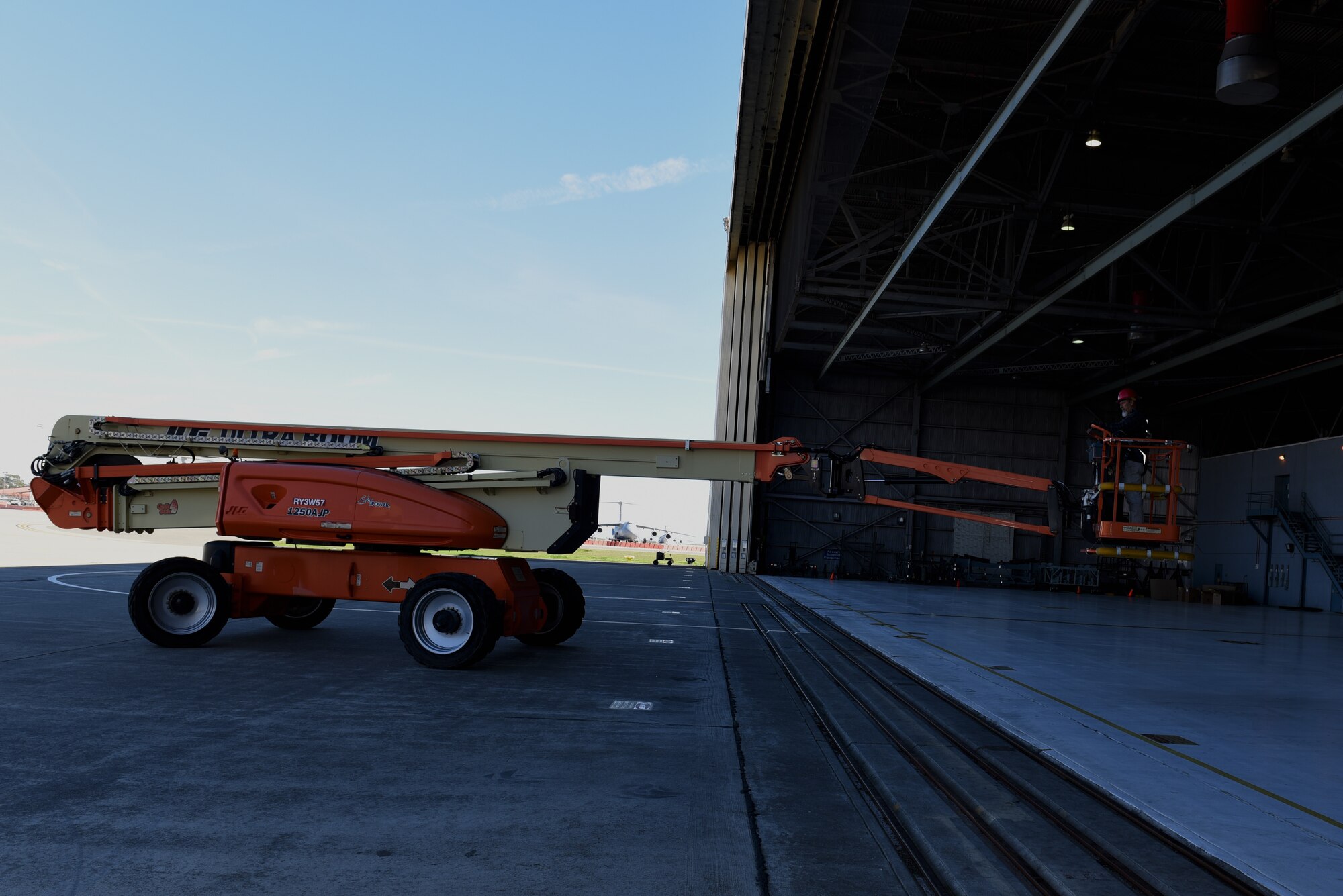 Randall Ollenberger, 60th Civil Engineering Squadron electrician, positions an Ultra Boom Lift March 14, 2019, at Travis Air Force Base, California. An Ultra Boom Lift is a large crane used to lift a person up to reach places in need of repair. (U.S. Air Force photo by Airman 1st Class Cameron Otte)