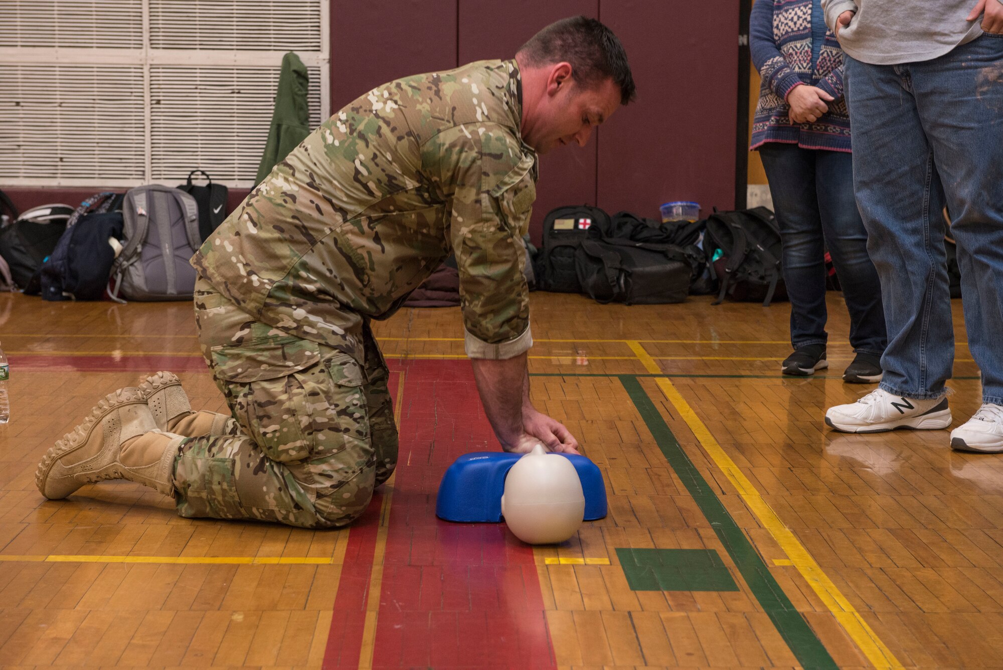 Master Sgt. Darrel Hanrahan, an Aerospace Medical Technician assigned to the 103rd Medical Group, demonstrates chest compressions on a CPR manikin during a CPR class at Torrington High School,  Torrington, Conn., March 22. Airmen from the 103rd Medical Group volunteered to help students meet requirements for their physical education class. (U.S. Air National Guard photo by Staff Sgt. Steven Tucker)