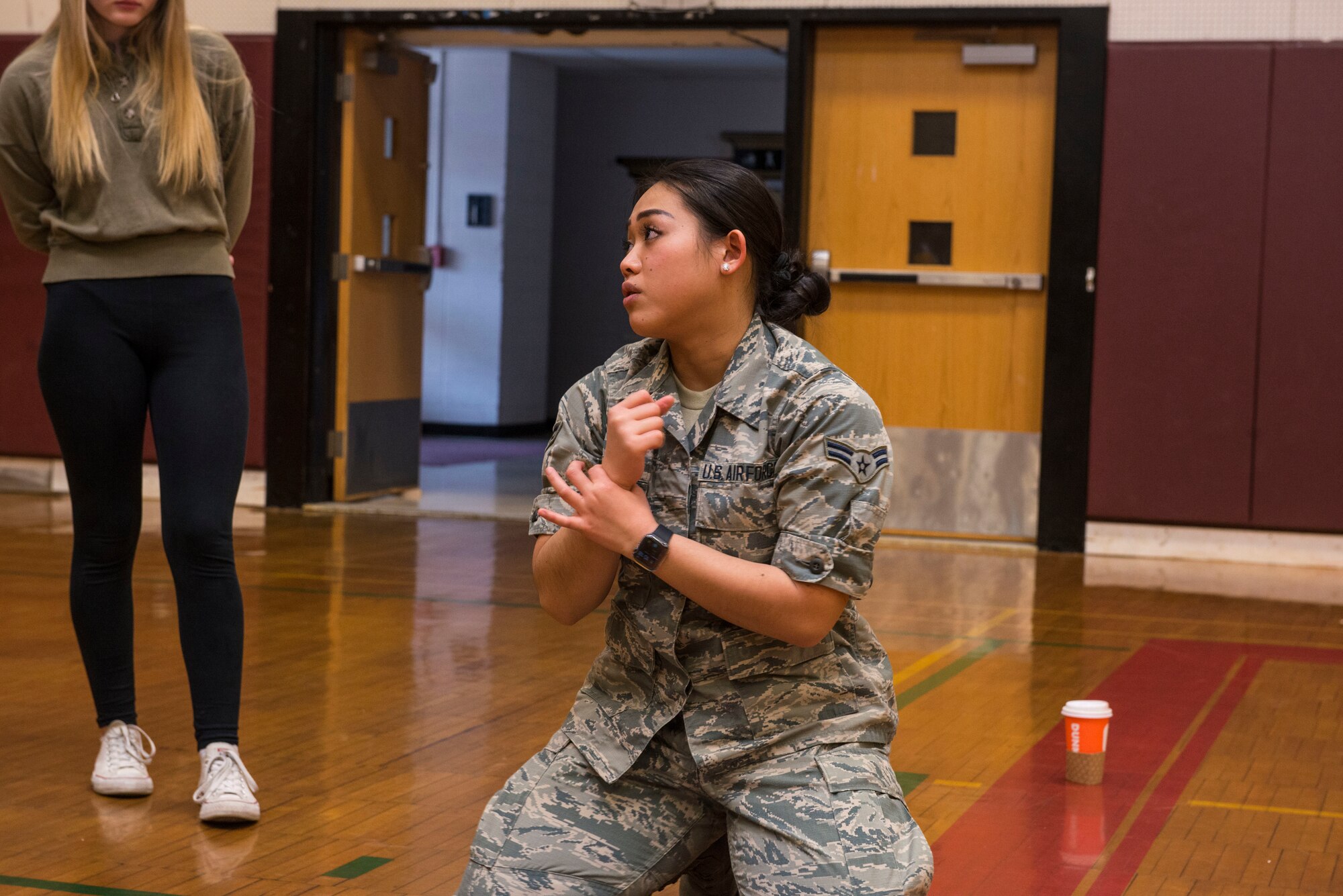 Airman 1st Class June Lee, an Aerospace Medical Technician assigned to the 103rd Medical Group, helps teach a CPR class at Torrington High School, Torrington, Conn., March 22. Airmen from the 103rd Medical Group volunteered to help students meet requirements for their physical education class. (U.S. Air National Guard photo by Staff Sgt. Steven Tucker)