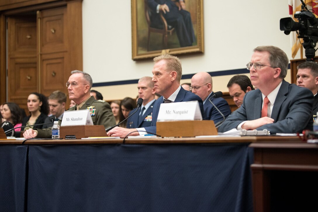 Acting Defense Secretary Patrick M. Shanahan, Marine Corps Gen. Joe Dunford and David L. Norquist sit at a table alongside each other.