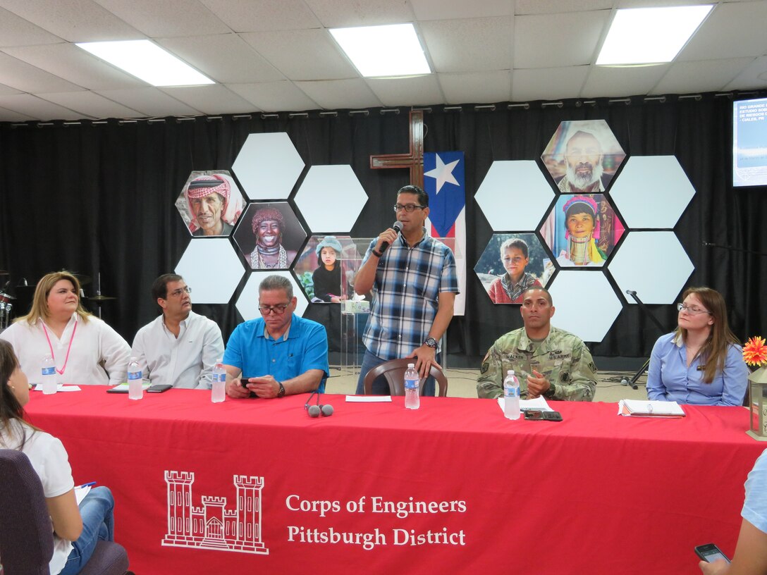 USACE personnel at a table addressing the audience in Ciales, Puerto Rico