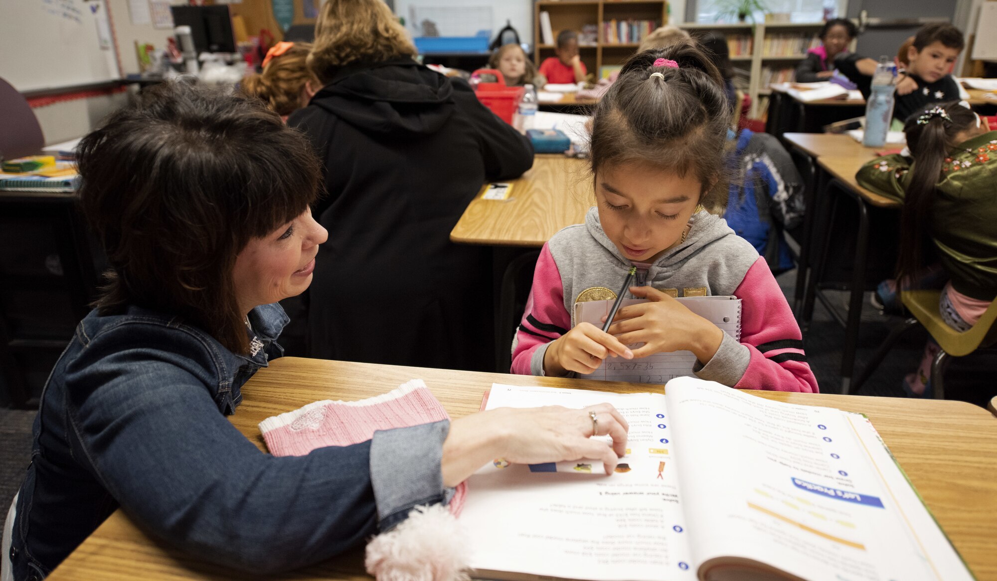 Kelly Barrett, spouse of the 18th Air Force commander, Maj. Gen. Sam Barrett, interacts with a student March 6, 2019, at Scandia Elementary School, Fairfield, California. Barrett visited the school to discuss the military-friendly enrollment policies that Travis Unified School District has instituted to accommodate as many military families as possible in a district with an increasing civilian population.