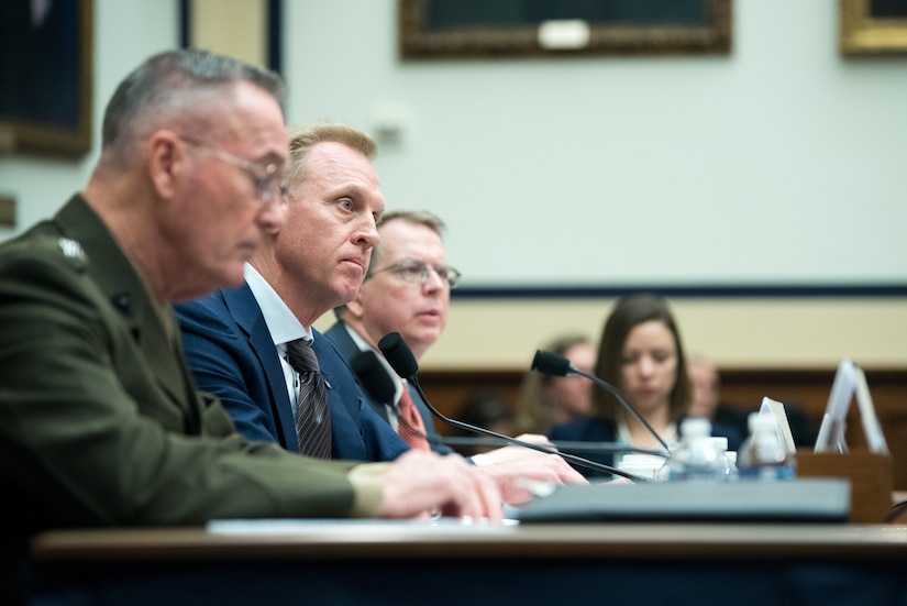 Two men speak before the House Armed Services Committee.
