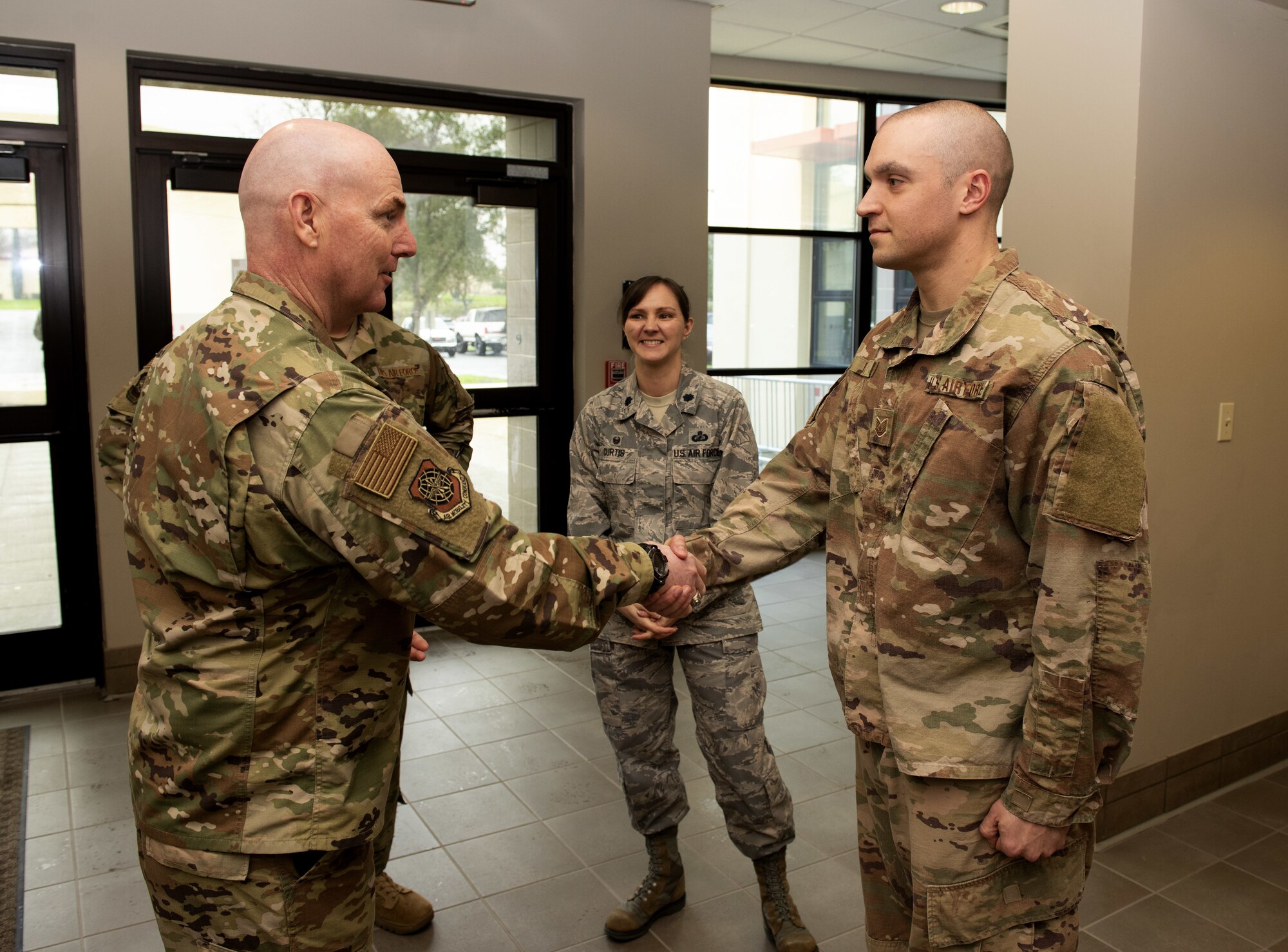 U.S. Air Force Maj. Gen. Sam Barret, 18th Air Force commander, coins U.S. Air Force Tech. Sgt. Eric Wiltz, NCO in charge Simplified Acquisitions Flight, 60th Contracting Squadron, March 7, 2019, at Travis Air Force Base, California. During the visit, Gen. Barrett received a first-hand look at the Travis mission and engaged with Airmen who support the mission (U.S. Air Force by Airman First Class Jonathon Carnell)