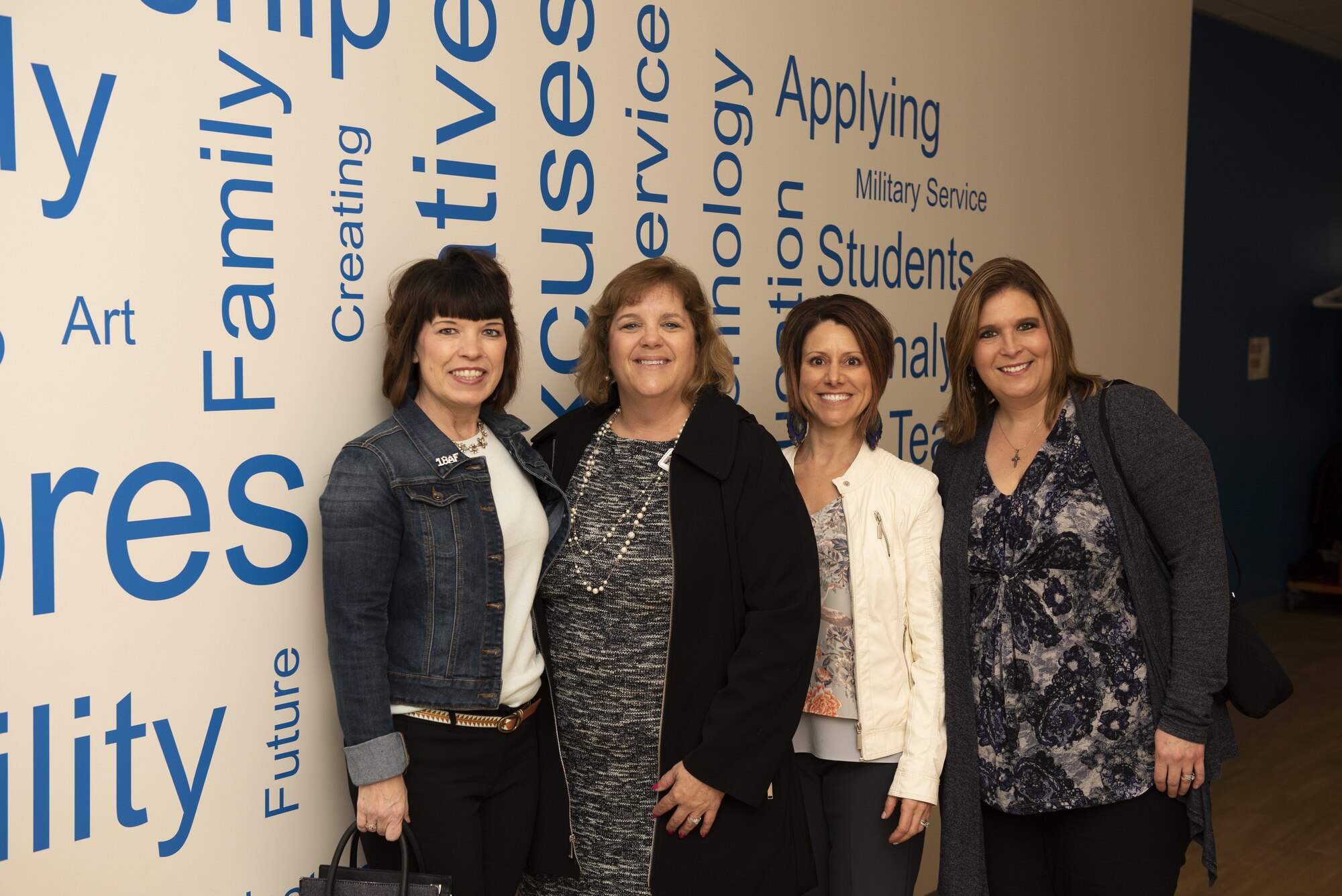 Kelly Barrett, spouse of the 18th Air Force commander, Maj. Gen. Sam Barrett; Pam Conklin, Travis Unified School District superintendent; Courtney Nelson, spouse of 60th Air Mobility Wing commander, Col. Jeff Nelson and Tia Crowder, spouse of 60th Air Mobility Wing command chief, Chief Master Sgt. Derek Crowder, pose for a photo March 6, 2019, at Scandia Elementary School, Fairfield, California. Barrett visited the school to discuss the military-friendly enrollment policies that Travis Unified School District has instituted to accommodate as many military families as possible in a district with an increasing civilian population.