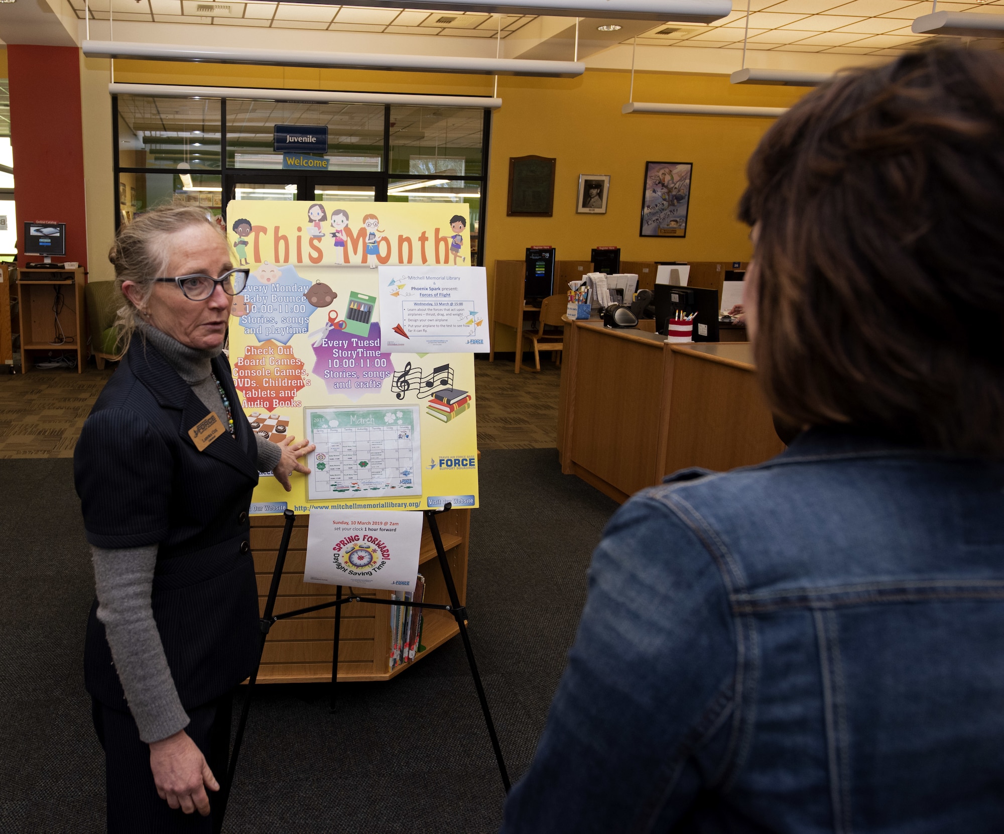 Lanora Cox, supervisory librarian, briefs Kelly Barrett, spouse of the 18th Air Force commander, U.S. Air Force Maj. Gen. Sam Barrett, during a base visit March 6, 2019 at the base library, Travis Air Force Base, California. The purpose of the visit was to show the various programs and opportunities available to both spouses and dependents at Travis AFB.