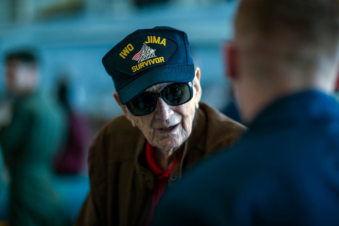 Ret. Master GySgt. Len Maffioli, an Iwo Jima veteran, speaks with Marines from Marine Fighter Attack Training Squadron (VMFAT) 101 during a veteran reunion tour at Marine Corps Air Station Miramar, Calif., March 22. The West Coast Iwo Jima Reunion Association and MCAS Miramar hosted this reunion for Iwo Jima veterans and their family members to learn about new advancements in the Marine Corps. (U.S. Marine Corps photo by Sgt. Jake McClung)
