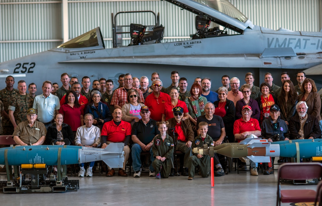 Marines from Marine Corps Air Station Miramar and members of the West Coast Iwo Jima Reunion Association pose for a photo during an Iwo Jima veterans reunion tour at MCAS Miramar, Calif., March 22. The West Coast Iwo Jima Reunion Association and MCAS Miramar hosted this reunion for Iwo Jima veterans and their family members to learn about new advancements within the Marine Corps. (U.S. Marine Corps photo by Sgt. Jake McClung)