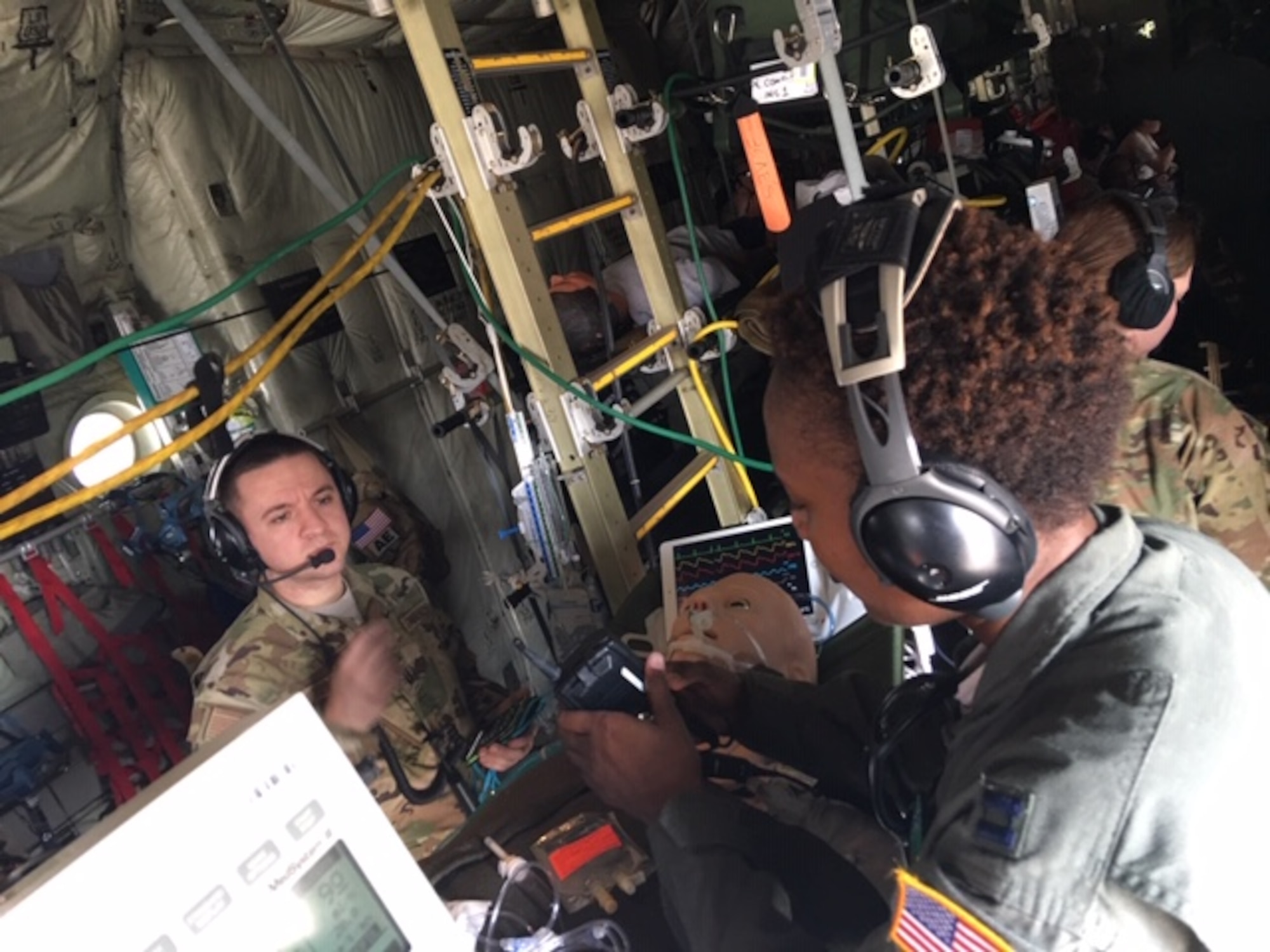 Capt. Thomas Ross, exercise trainer and an 81st Medical Group Critical Care Air Transport Team registered nurse (left) and Capt. Shartia Bowers, a CCATT registered nurse (right) work inside a C-130J Super Hercules aircraft during an exercise March 10, 2019, at Keesler Air Force Base, Miss., involving the Air Force Reseve Airmen of the 403rd Wing's 36th Aeromedical Evacuation Squadron and the 815th Airlift Squadron and active duty Air Force service members of the 81st MDG CCATT.  All three military units are at Keesler Air Force Base, Miss. (U.S. Air Force Photo by Lt. Col. Ryan Mihata).