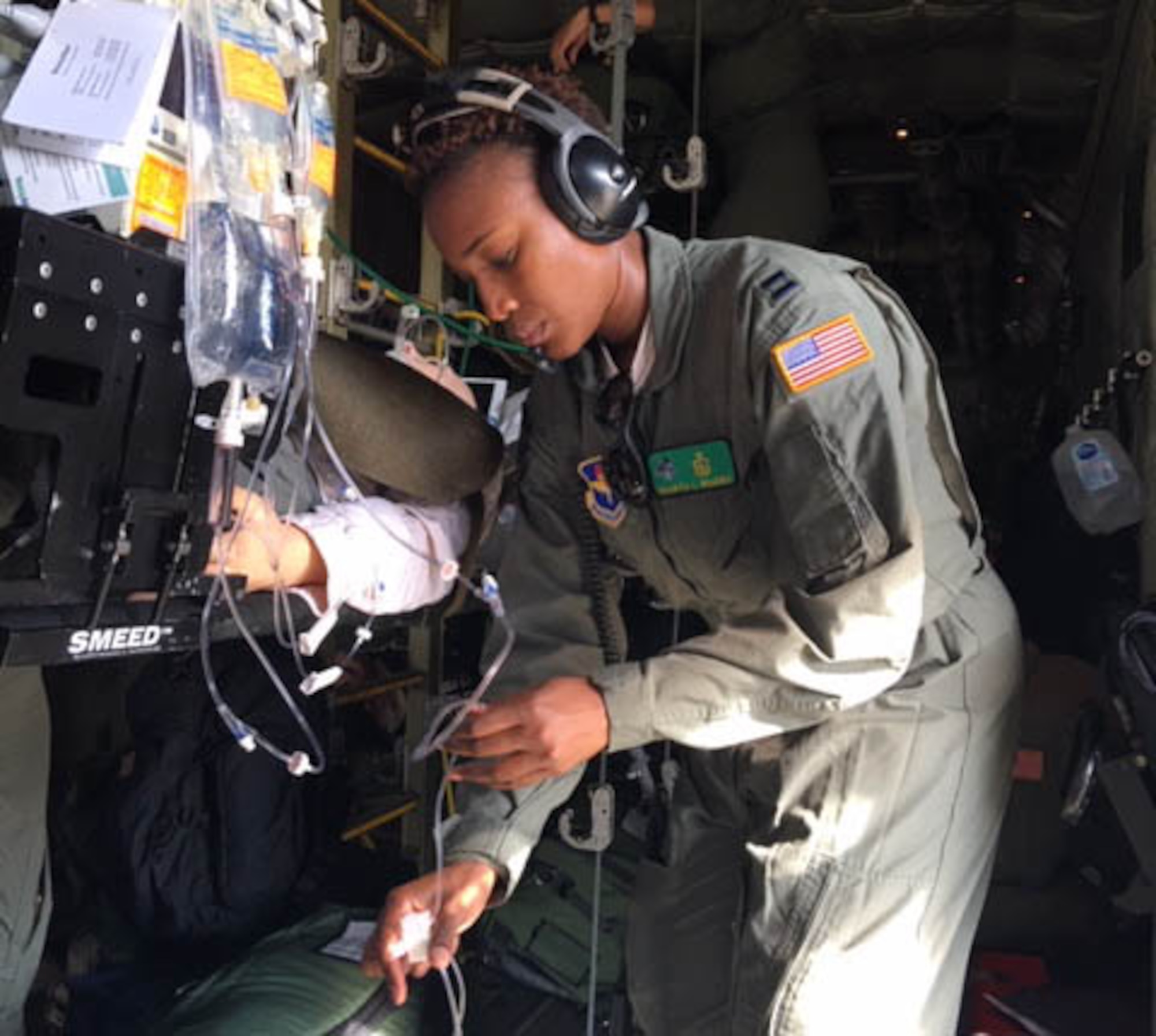 Capt. Sharita Bowers, a registered nurse with the 81st Medical Group's Critical Care Air Transport Team, checks an IV line for a simulated patient during a training exercise March 10, 2019, onboard a C-130J Super Hercules aircraft at Keesler Air Force Base, Miss. The exercise involved the Air Force Reseve Airmen of the 403rd Wing's 36th Aeromedical Evacuation Squadron and the 815th Airlift Squadron and active duty Air Force service members of the 81st Medical Group's CCATT. All three military units are at Keesler Air Force Base, Miss. (U.S. Air Force Photo by Lt. Col. Ryan Mihata)