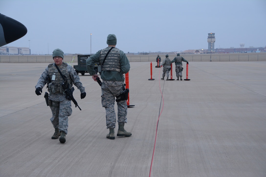 Senior Airman Steven Hill, 507th Security Forces Squadron, and a team of 507th SFS defenders set up a perimeter to secure aircraft on the flightline during an aircraft generation exercise geared toward wartime preparation and readiness March 2, 2019, at Tinker Air Force Base, Oklahoma. The 507th Air Refueling Wing's unit effectiveness inspection capstone event is scheduled for Nov. 15-19, 2019. (U.S. Air Force photo by Tech. Sgt. Lauren Gleason) (This photo has been altered for security purposes by blurring out identification badges.)