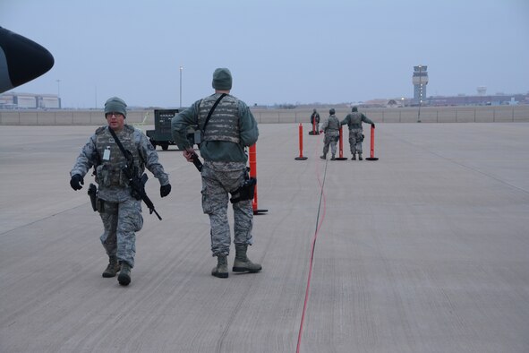Senior Airman Steven Hill, 507th Security Forces Squadron, and a team of 507th SFS defenders set up a perimeter to secure aircraft on the flightline during an aircraft generation exercise geared toward wartime preparation and readiness March 2, 2019, at Tinker Air Force Base, Oklahoma. The 507th Air Refueling Wing's unit effectiveness inspection capstone event is scheduled for Nov. 15-19, 2019. (U.S. Air Force photo by Tech. Sgt. Lauren Gleason) (This photo has been altered for security purposes by blurring out identification badges.)