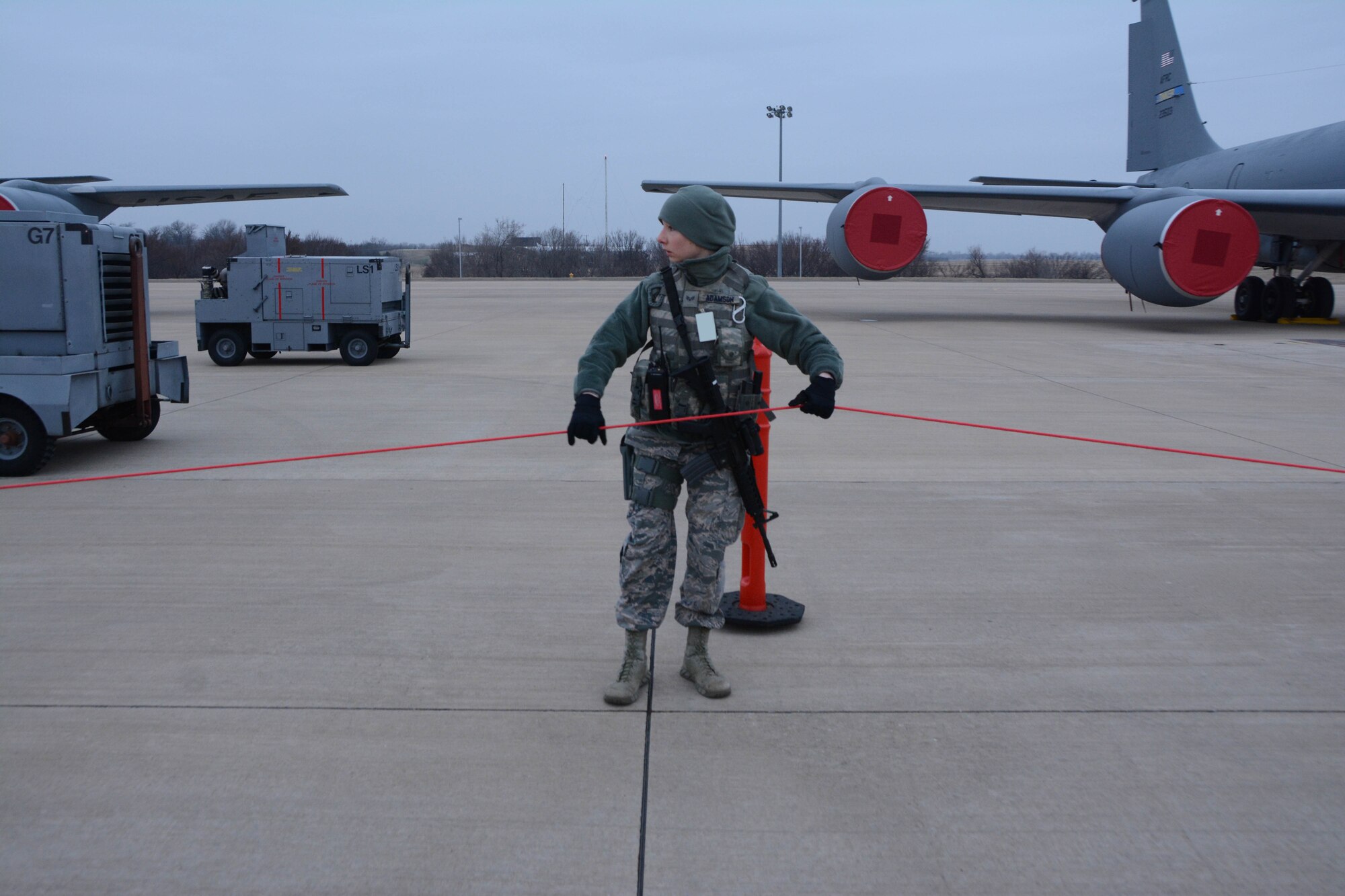 Senior Airman Taylor Adamson, 507th Security Forces Squadron, ropes off a secure perimeter around the aircraft on the flightline during an aircraft generation exercise geared toward wartime preparation and readiness March 2, 2019, at Tinker Air Force Base, Oklahoma. The 507th Air Refueling Wing's unit effectiveness inspection capstone event is scheduled for Nov. 15-19, 2019. (U.S. Air Force photo by Tech. Sgt. Lauren Gleason) (This photo has been altered for security purposes by blurring out identification badges.)