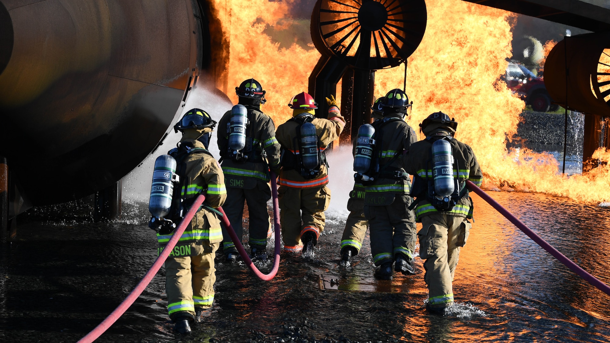 U.S. Air Force firefighters from the 2nd Civil Engineering Squadron and firefighters from the Shreveport Fire Department put out a simulated aircraft fire March 21, 2019, at Barksdale Air Force Base, Louisiana. The firefighters simulated spraying a foam blanket over the fire, to remove oxygen from the flames and put out the fire. (U.S. Air Force photo by Airman Jacob B. Wrightsman)