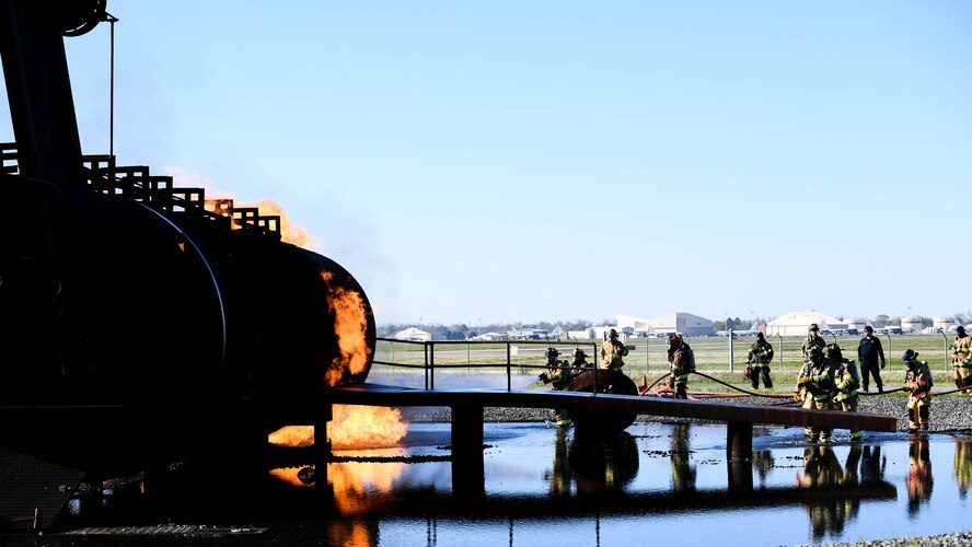U.S. Air Force firefighters from the 2nd Civil Engineering Squadron and firefighters from the Shreveport Fire Department put out a simulated aircraft fire March 21, 2019, at Barksdale Air Force Base, Louisiana. The exterior of the aircraft can be used to simulate multiple engine fires, debris fires and fuel fires. (U.S. Air Force photo by Airman Jacob B. Wrightsman)