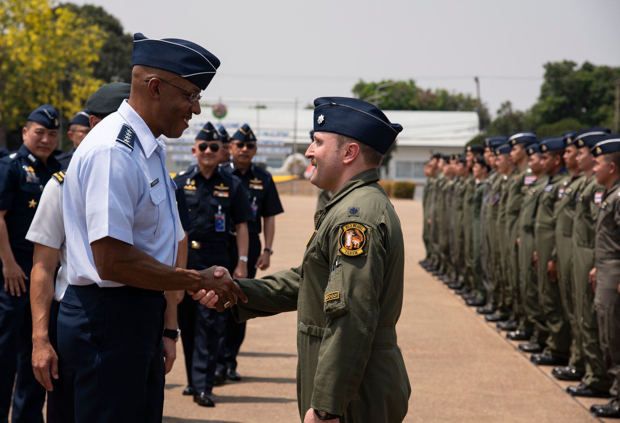 U.S. Air Force Gen. CQ Brown Jr., Pacific Air Forces commander, shakes hands with Lt. Col. Matthew Kenkel, 14th Fighter Squadron commander following the closing ceremony for COPE Tiger 2019 at Korat Royal Thai Air Force Base, Thailand, March 22, 2019.