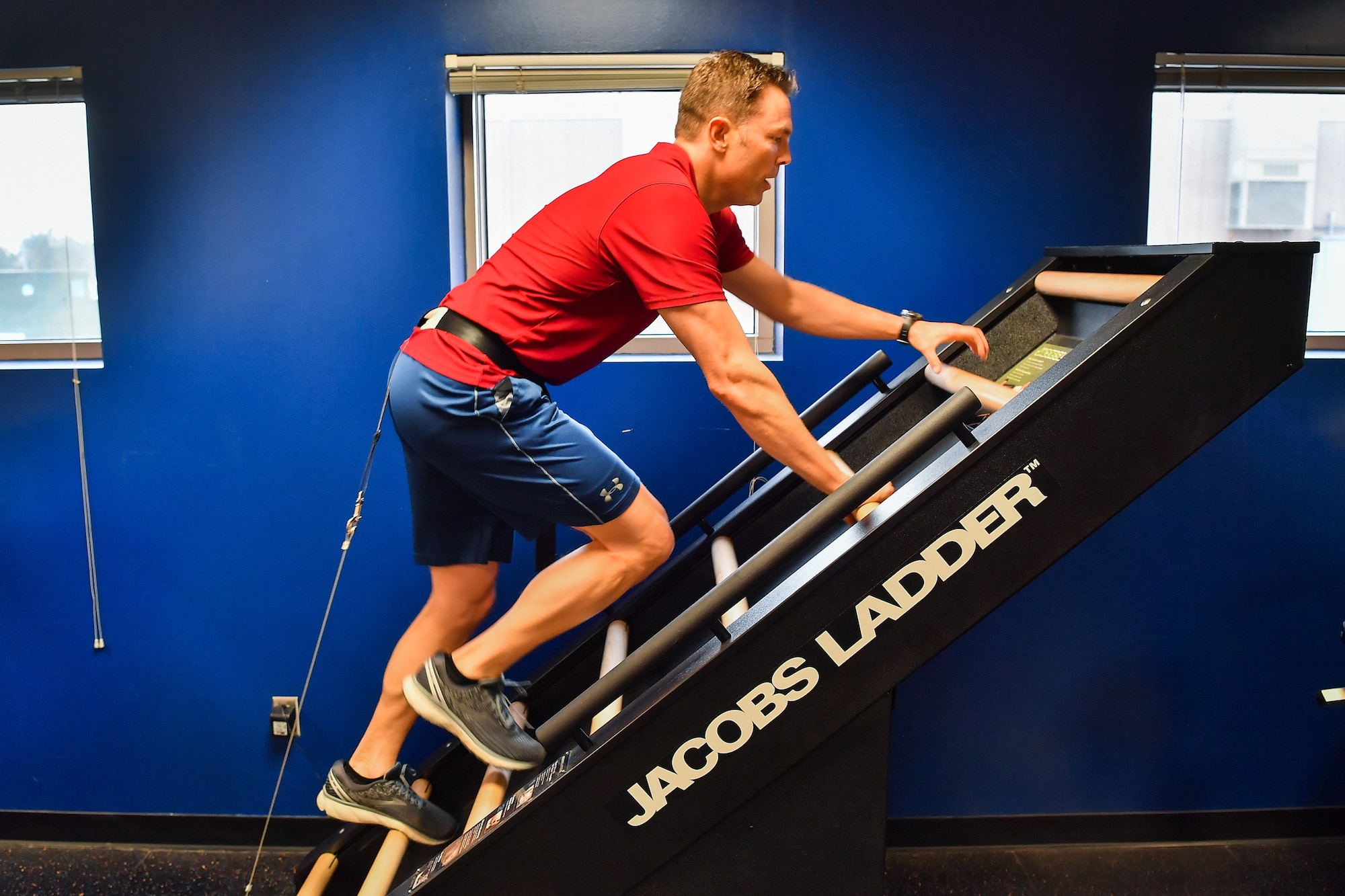 U.S. Air Force Capt. Wesley Althaus, 50th Operations Group Standardization and Evaluation Flight, climbs an exercise machine during the Heart Health Fair at Schriever Air Force Base, Colorado, March 26, 2019. The machine is designed to create a high intensity, low-impact exercise. (U.S. Air Force photo by Kathryn Calvert)
