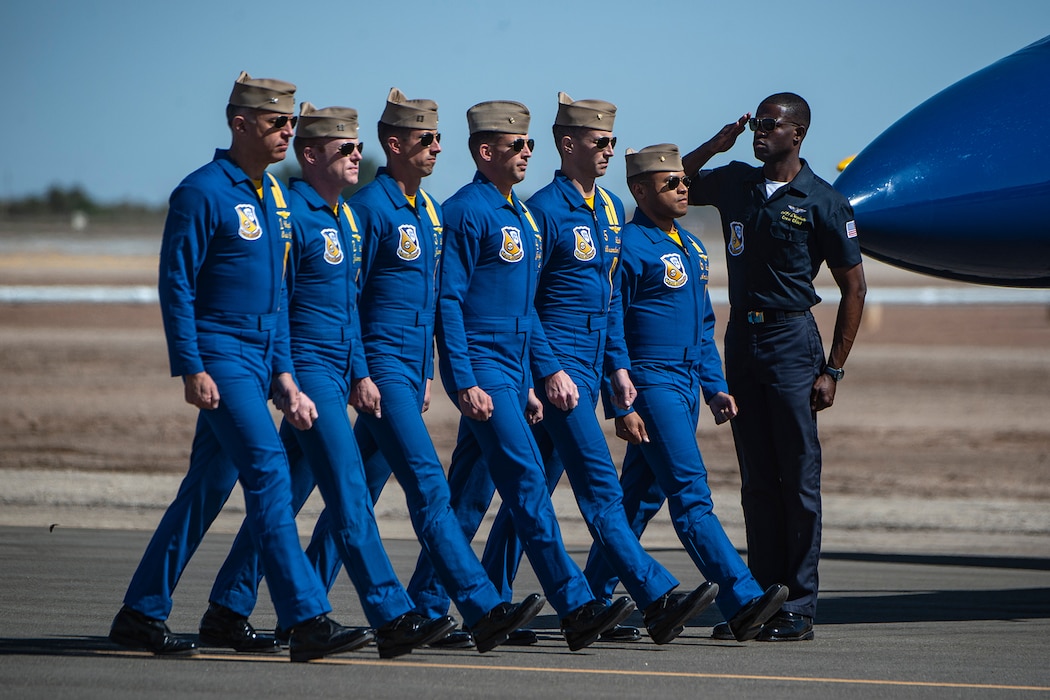 Navy pilots walk in a line.