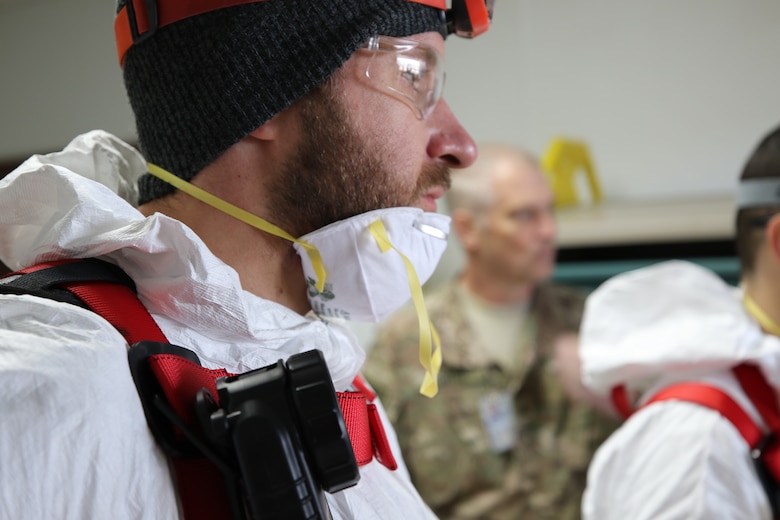 Keith Grezlik and Art Wolf, Environmental Response Team discuss the execution strategy for the safe entry of the crawl space. Huntsville Center provides support to the United States Forces-Afghanistan through a contract with AECOM’s Environmental Response Team. The ERT’s primary mission was to vent and provide fresh air to the confined space, and monitor the air quality during the assessment.